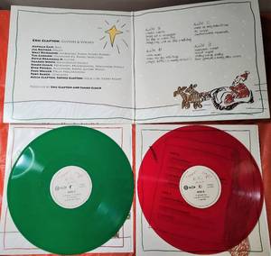 lot 27 image: New  Happy Xmas LP, 45 RPM, Album Red 180 Gram Album - Eric Clapton and Simon Climie Vocals
