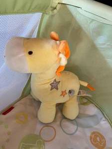 lot 87 image: Fisher Price Portable Basinet with Stuffed Giraffe