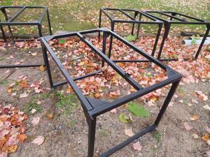 5 METAL FRAMES ON CASTORS.
