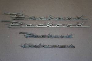 lot 175 image: 1955-56 Packard Patrician Name Badges