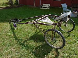 lot 102 image: Wood sulky form simpson stables with some harness. Ready to use. As shown.
