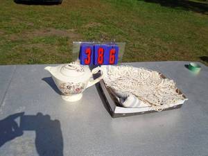 lot 386 image: Flat of tea pot & linens. As shown.