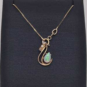 Diamond & White Opal Pear Cabochon Ribbon Swirl Pendant in 14k Yellow Gold
