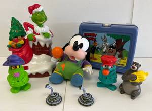 lot 104 image: Group Of Misc. Disney Items Including Looney Toons Lunch Box, Dr, Seuss The Grinch Battery Operated Bank (Works) And More -