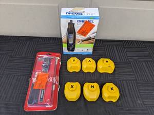 lot 140 image: Dremel Lite 7760 4V Variable Speed Lithium Ion Cordless Rotary Tool Kit with Accessories, Husky 6 in. 3-Mode Digital Fractional Caliper and Pebble Creek Cut A Creation for Scrap Book Making Letters A, H, K, P, W and X