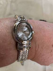lot 58 image: NEW. Silvertone Watch. Comes With Black Velvet Bag, Made By Studio. Goldtone Watch-Made By Cardell With Crystal Accents