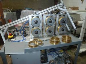 lot 23 image: Drawing equipment bench - Nice heavy steel bench with various filament drawing reels etc