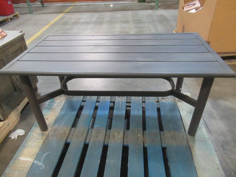 lot 554 image: Aluminum Outdoor Coffee Table. Approximate Dimensions 46 x 24 x 20 12 Tall. Slight DimpleDent on Edge (See Photos).   SOLD AS PICTURED.