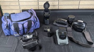 Vintage Camera Lot  Camera Bag, Scotch XSI and XSII tapes, Minolta Hi-Matic E, Minolta 20 Flash, Nikon M90, Camera Lenses, and Cases