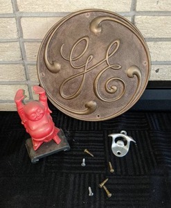 Very Mixed Lot  General Electric Emblem, Small Red Buddha and a Vintage 7-Up Wall Mounted Bottle Opener