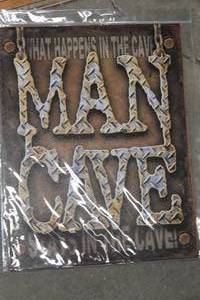 lot 555 image: Man Cave - What Happens In The Cave Stays In The Cave Metal Sign