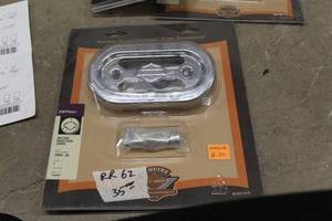 lot 182 image: Harley-Davidson 74582-00 Softtail Motorcycle Voltage Regulator Cover (in original packaging)