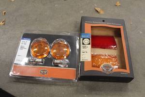 lot 677 image: Harley-Davidson Motorcycle Lights and Light Covers (New) - Bullet Smoked Turn Signal Visor 69785-05, Chrome Fender Tip Lens 59081-96