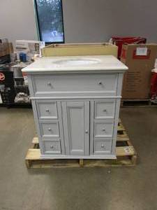 lot 779 image: HOME DECORATORS COLLECTION Hampton Harbor 28 in. Vanity in Dove Grey with Natural Marble Vanity Top in White with White Sink (SMALL DAMAGE ON TOP IN CORNER, SEE PHOTOS)