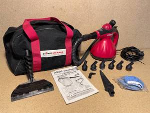lot 49 image: Scunci Portable Steamer and Cleaner, includes the carrying bag, manual, and all of its attachments