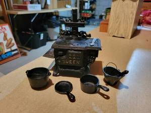 lot 343 image: Miniature QUEEN Cast Iron Stove with Pot, Pan, Cauldron, Burner Covers, Coal Bucket, Shovel, and MORE