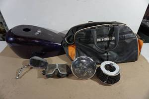 lot 134 image: Harley-Davidson Bag with Gas Tank Cover and Parts - Vintage Goggles