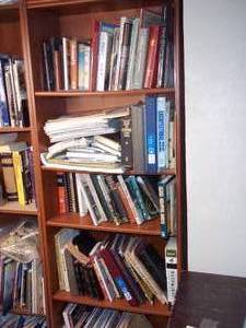 lot 381 image: Bookshelf filled with books and oth...
