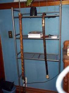 lot 390 image: Metal rack with vintage canes books...