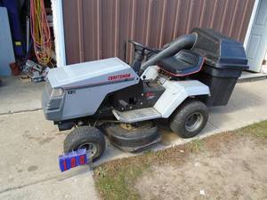 lot 100 image: Craftsman 12 hp with dual bagger. 5 speed. Tested & works. As shown.