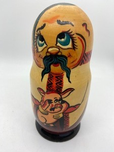 lot 376 image: Vintage Russian Nesting Doll (Matryoshka) - Funny Character with Pig, Carving Knives, and Vodka Bottle - Made in Russia