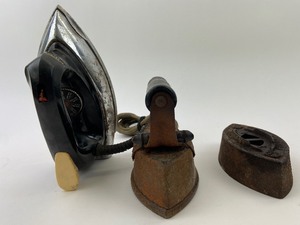 lot 304 image: Irons of the Ages - Wrinkle Removers  Door Stops - Two Flat Irons, One Electric