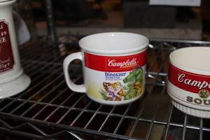 lot 570 image: Campbells Soup Dinosaur Vegetable Soup Soup Cup