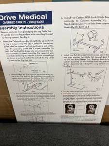 DRIVE MEDICAL OVERBED TABLE APPEARS NEW IN DAMAGED BOX - TOP WOOD GRAIN PIECE HAS VERY SLIGHT DAMAGE TO EDGE - SEE PICS