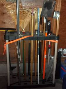 lot 331 image: Garage rack filled with yard tools...