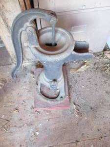Antique Manual Water pump on affixe...