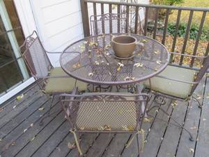 Round Dark metal patio table capabl...
