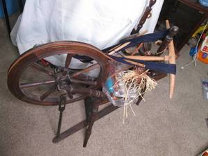 Antique spinning wheel with yarn...
