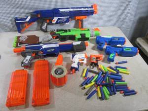 lot 26 image: (RM3) 7 Assorted Nerf Guns with Cli...