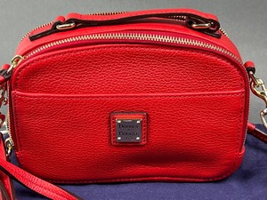 lot 6 image: Dooney and Bourke Wexford Smooth Leather Amber Crossbody Handbag