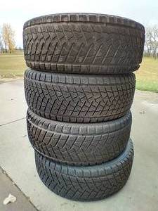 lot 18 image: (4) 24550R20 Ice Tires - Studdable & Good Tread