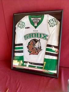 lot 164 image: Framed Sioux Hockey Jersey