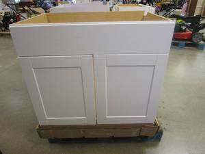 lot 64 image: HAMPTON BAY Shaker Satin White Stock Assembled Sink Base Kitchen Cabinet (36 in. x 34.5 in. x 24 in.) (BACK CORNER MISSING, SEE PHOTOS)