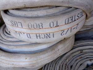 lot 128 image: Two Pallets with more than a Dozen Rolled-Up High Pressure Hose 2.5-inches and Smaller