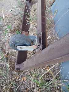 lot 135 image: 32.5-inch X 90-inch Heavy Duty Metal Dolly, 1.5-inch x 2-inch Angle Iron and Swivel Casters at one end