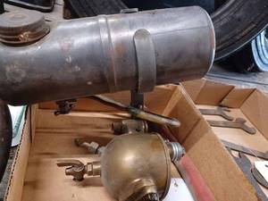 lot 147 image: Box with Gas Tank, Brass Part - The Schebler, Indianapolis, IND., and an Automatic Oiler - American Injector Co. Detroit U.S.A.