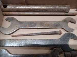 lot 152 image: Assorted Unmarked Antique Wrenches, Specialized Pliers, 7 12-inch Eaton Piston, and a 6-inch Square Nail
