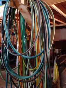 lot 239 image: Seven Garden Hoses, Five Pieces of New Assorted Exhaust Hose, and Two Automotive Fluid Spill Sponges