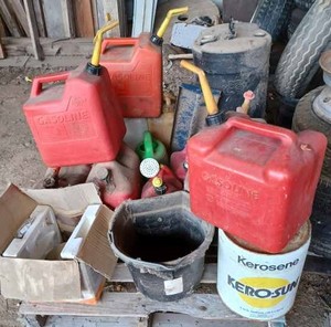 lot 244 image: Pallet of 17 Plastic Gas Cans and a Pallet of Seven Plastic Gas Cans, Small Plastic Barrel, Rubber Pail, Light Fixture, Watering Can and More