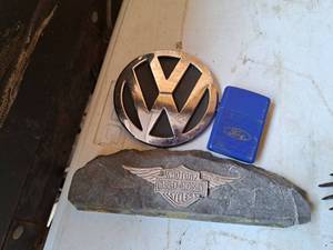 lot 406 image: Lot of (3) Automotive Memorabilia - VW Emblem, Harley-Davidson Plaque, Ford Butane Lighter