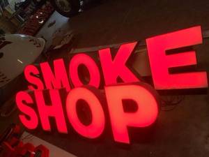 lot 7 image: Smoke Shop lit channel letters mounted on raceway