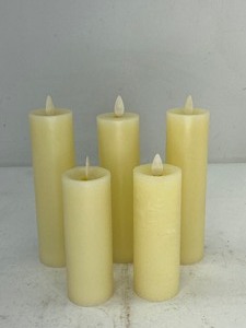 lot 469 image: 4 Luminara Ivory Flameless Pillar Candles with Two Gold Colored Star Holders