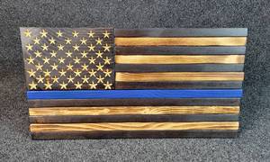 lot 3019 image: Thin Blue Line American Flag Handcrafted Wooden Flag by Vance Stuehrenberg of Red Lights Woodwork