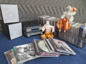 SMALL LAZER DISC PLAYER WITH TWO SMALL SPEAKERS.  CLOWNS CDS