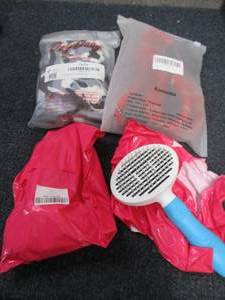 lot 192 image: Dog leash, XS Hoodie, 2 Grooming Br...