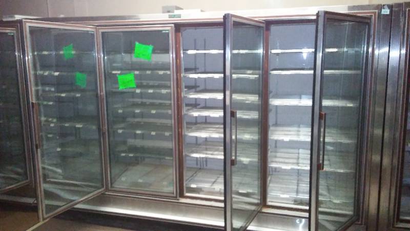 lot 24 image: Free Standing Display Freezer (11 Door). Zero Zone, working properly, 370 in. L x 80 in. H x 36 in. D.